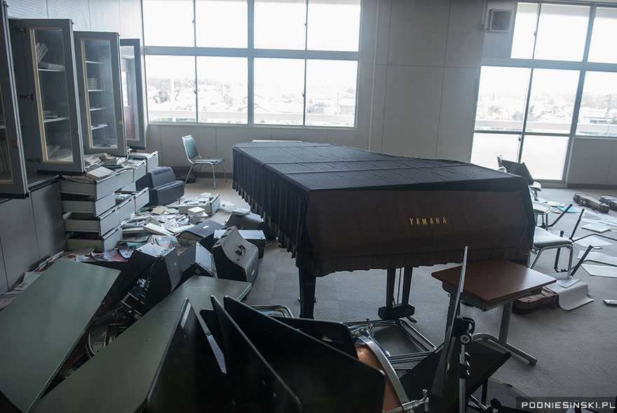 11-Musical instruments including a piano litter the floor of this classroom