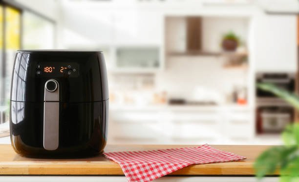 Air fryer machine cooking potato fried in kitchen.