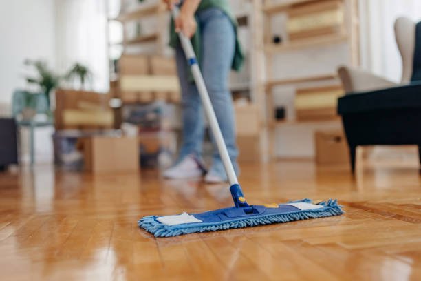 Unrecognisable women cleaning the floor using cleaning rag